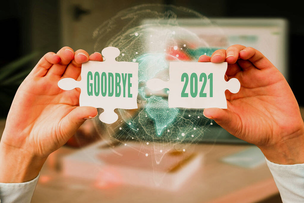 Inspiration showing sign Goodbye 2021. Business approach express good wishes when parting or at the end of last year Business Woman Holding Jigsaw Puzzle Piece Unlocking New Futuristic Tech. - Photo, Image