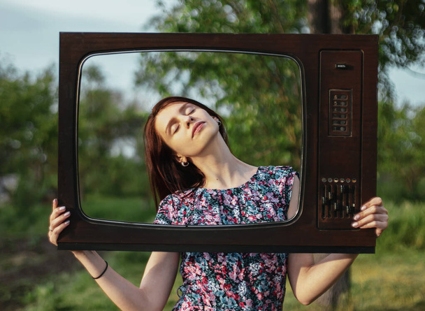 Portrait of young woman inside old retro television frame with closed eyes, technology and publicity mental problems - Photo, Image
