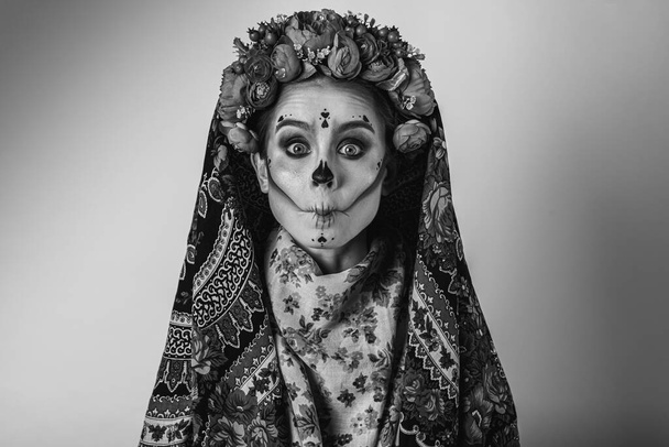 black and white emotional portrait, Calavera Katrina demonstrates various emotional gestures to the body, face, in a headscarf, looks and from the side, a place for an inscription. Dia-de -los -muertos. Day of death. - Photo, Image