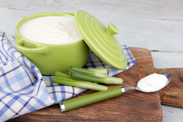 Green pan of cream on a napkin on cutting board - 写真・画像