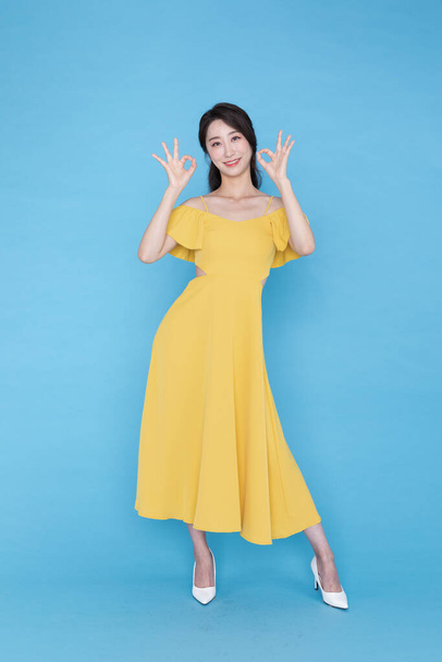 shopping event concept, smiling beautiful Korean Asian woman with hand motion - Фото, изображение
