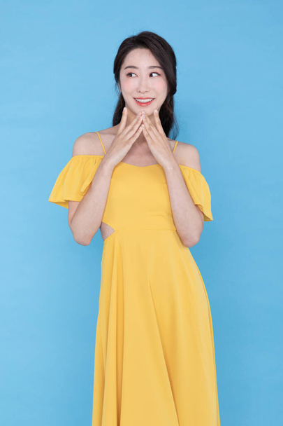 shopping event concept, smiling beautiful Korean Asian woman with hand near face - 写真・画像