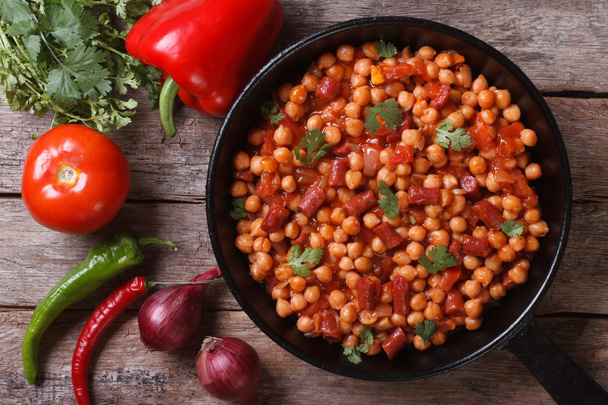 Chickpeas with chorizo in a pan with the ingredients top view - Photo, Image