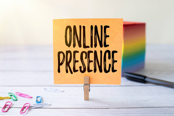 Handwriting text Online Presence. Business showcase existence of someone that can be found via an online search Blank Sticky Note Laundry Clip Stack Of Colorful Paper Pen Placed On Desk. - Photo, Image