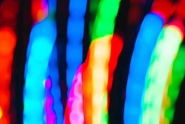 Festive abstract colored defocus background. Neon lights in motion blur - Foto, Imagen