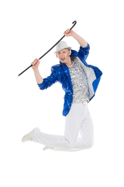 Man dancer in the blue sparkle suit and white trousers jumping - 写真・画像