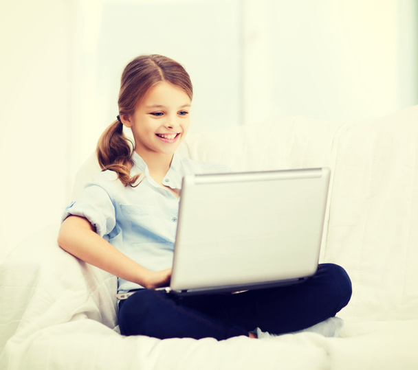 smiling girl with laptop computer at home - Фото, изображение