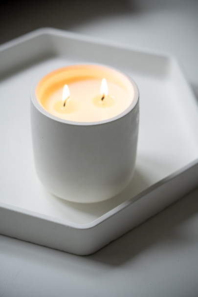 Burning candle with two wicks, handmade candle in white jar - Photo, Image