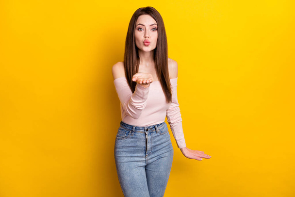 Photo of optimistic brunette lady blow kiss wear pink shirt isolated on yellow color background - Фото, зображення