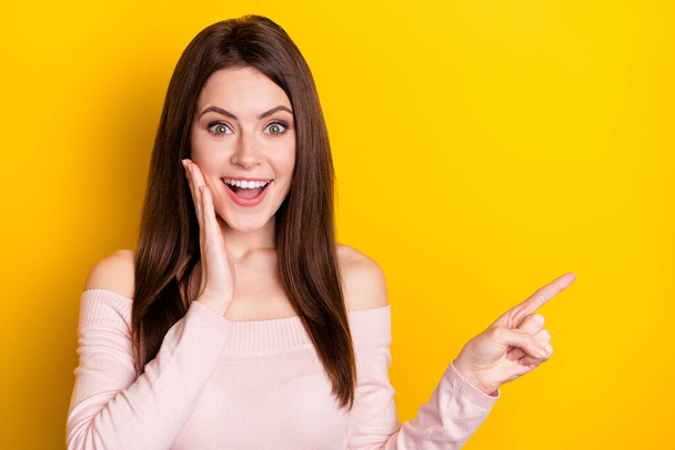 Photo of impressed brunette lady point empty space wear pink shirt isolated on yellow color background - Φωτογραφία, εικόνα