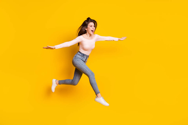 Full size photo of young crazy excited funky woman jumping flying look copyspace isolated on yellow color background - Foto, Imagem