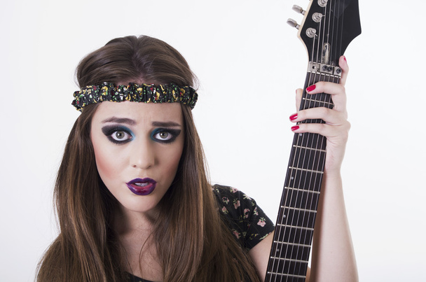Beautiful rocker punk girl with colorful makeup holding electric guitar - Foto, Imagem