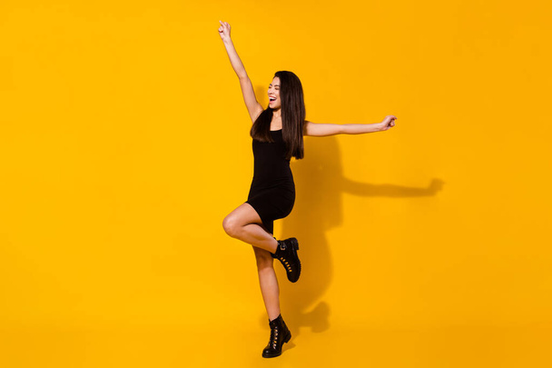Full body photo of cheerful young positive happy woman raise hands winner isolated on yellow color background - Фото, зображення