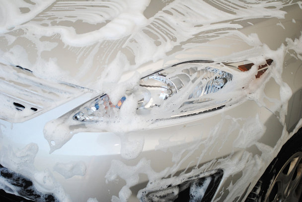 Car Covered with Soap Suds in a Washing Bay - Photo, Image