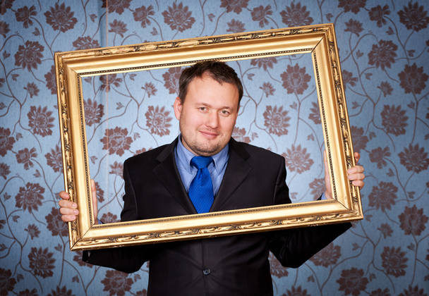 Businessman in golden frame on wallpapers - Фото, зображення