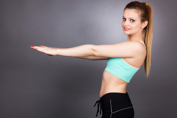 Young fitness woman doing squat exercises   - Valokuva, kuva