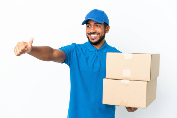 Delivery Ecuadorian man isolated on white background giving a thumbs up gesture - Фото, изображение