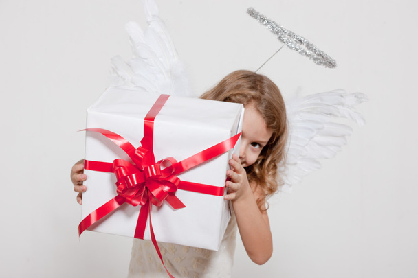 Girl with angel wings and set of gifts - 写真・画像