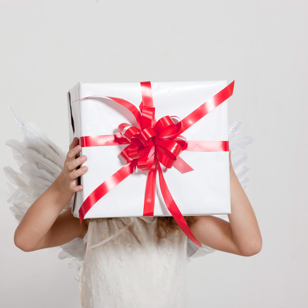 Girl with angel wings and set of gifts - Foto, immagini