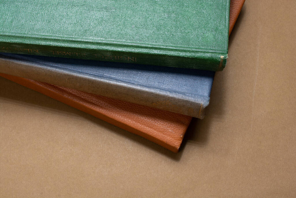 A closeup of colorful diaries on the brown surface - Фото, зображення