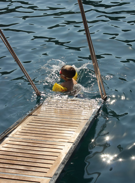 Um menino em uma natação no mar
 - Foto, Imagem