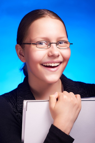 Young businesswoman in eyeglasses holds folder and smiling - Photo, image