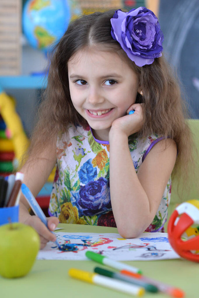 Cute  happy  girl drawing at desk  at home - Valokuva, kuva