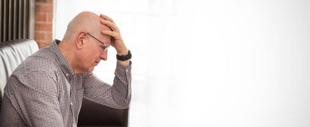 Older man has a headache. Senior healthcare concept. Web banner with copy space - Фото, изображение