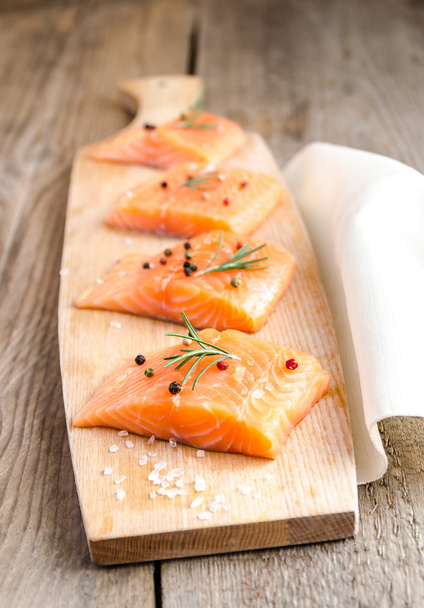 Raw salmon steaks on the wooden board - Photo, Image