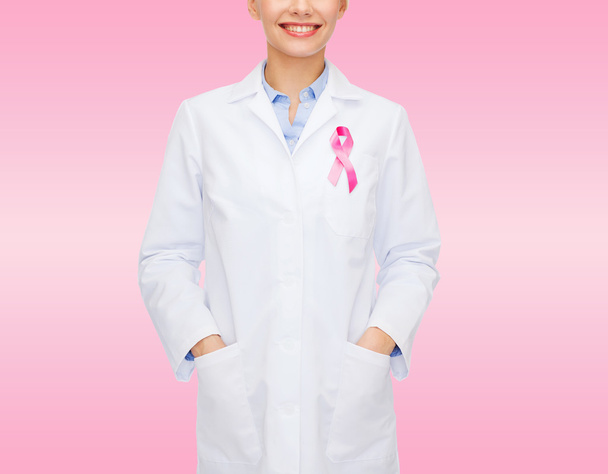 close up of doctor with cancer awareness ribbon - Foto, Imagem