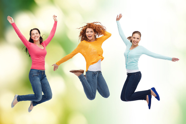 group of smiling young women jumping in air - Foto, imagen