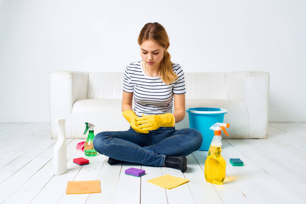 housewife near the sofa cleaning of the apartment light background - Photo, Image