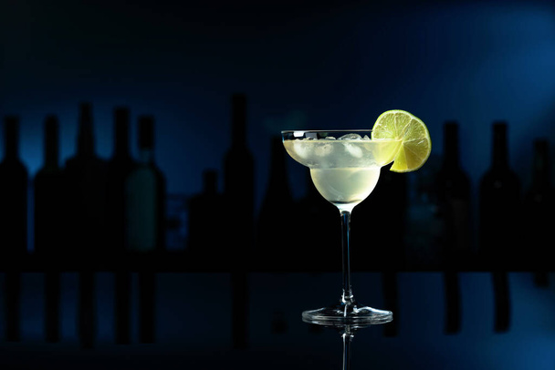 Cocktail "Margarita" on a black reflective background. Copy space. - Photo, Image