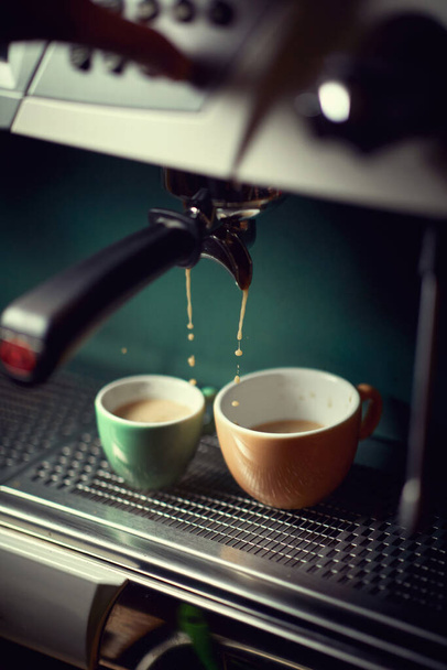 Hot coffee preparation.mug of fresh coffee on coffee maker machine. - Фото, изображение