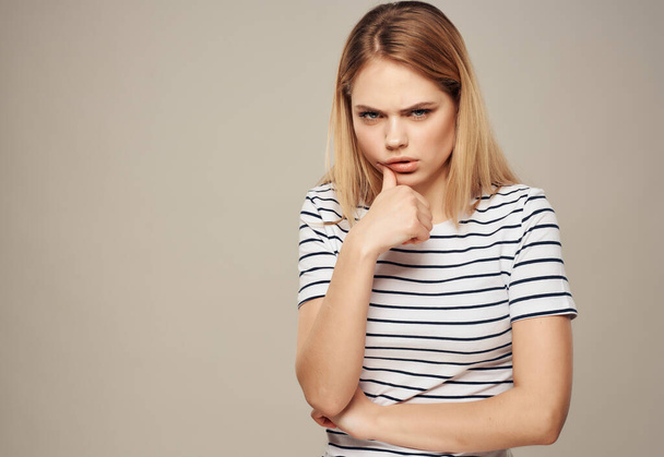 woman with angry facial expression striped t-shirt emotions Studio - Photo, Image