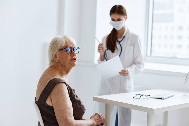 old woman patient on examination by a nurse health care - Foto, imagen