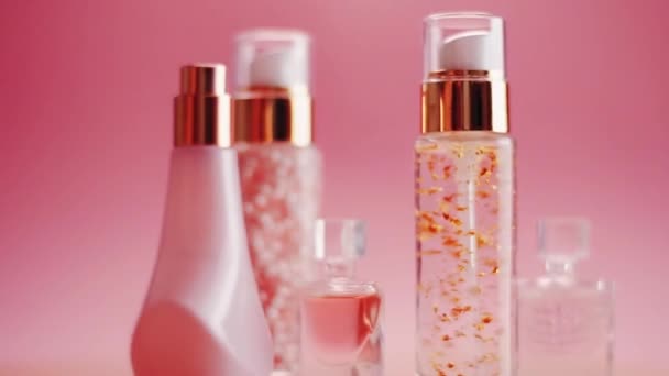 Beauty, make-up and cosmetics product promotion on pink background, perfume, fragrance and skincare bottles - Footage, Video