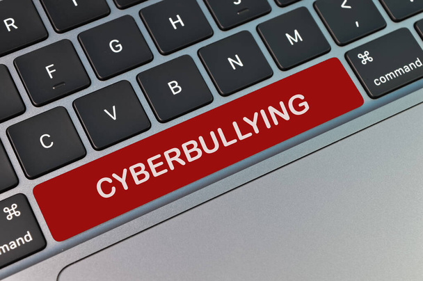 Top view of computer keyboard written with text CYBERBULLYING - Photo, Image