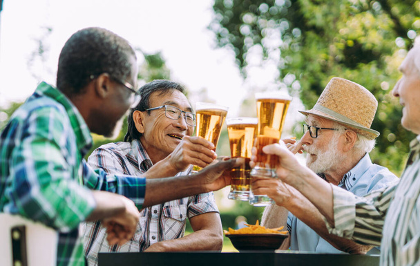 group of senior friends drinking a beer at the park. Lifestyle concepts about seniority and third age - Photo, image