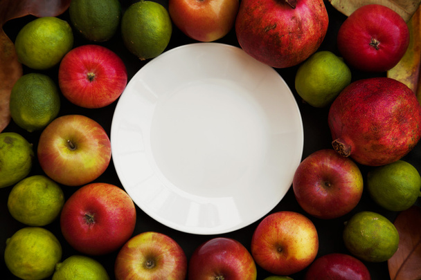 Red apples, pomegranate and limes - Zdjęcie, obraz