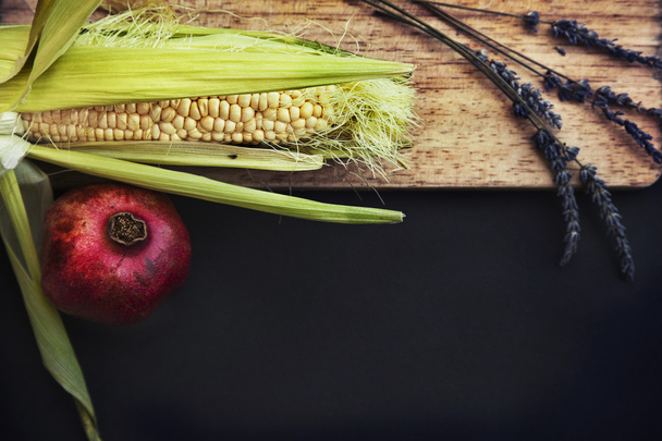 Corn, pomegranate fruit and herbs - Фото, зображення