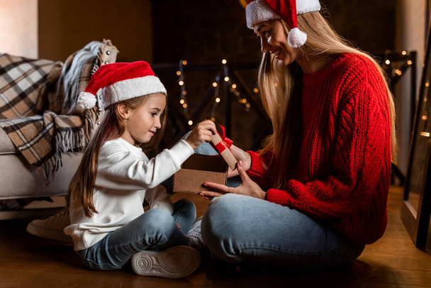 Portrait of happy woman and daughter celebrating xmas - Photo, Image