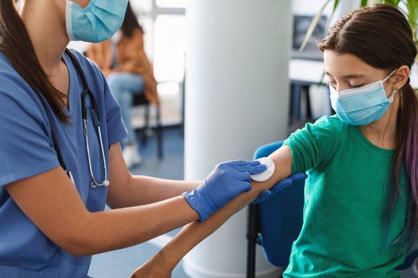 Dospívající pacient příprava na očkování, lékař dezinfekční kůže - Fotografie, Obrázek