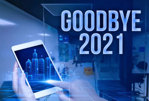 Text caption presenting Goodbye 2021. Business approach express good wishes when parting or at the end of last year Man In Uniform Standing Holding Tablet Typing Futuristic Technologies. - Photo, Image