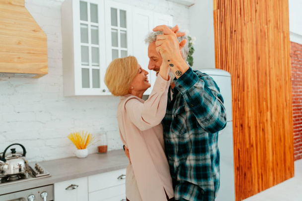 husband and wife dance at home during breakfast - Photo, Image