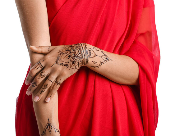 Beautiful Indian woman with henna tattoo on white background, closeup - Photo, Image
