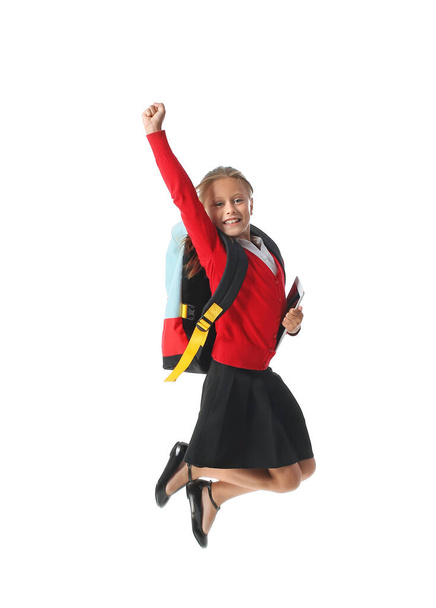 Jumping little schoolgirl on white background - Zdjęcie, obraz