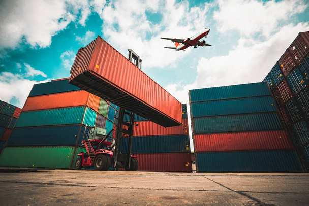 Vrachtcontainer voor overzeese scheepvaart in scheepswerf met vliegtuig in de lucht . - Foto, afbeelding