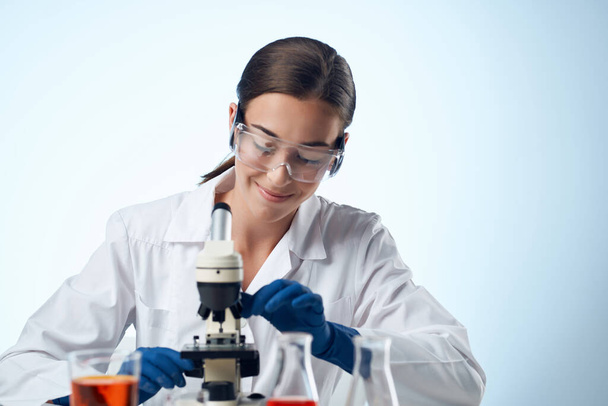 female laboratory assistant at work table microscope professional - Photo, Image