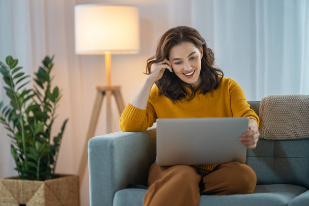 Happy casual beautiful woman using laptop at home. - Photo, image